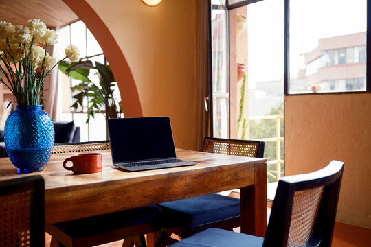 Laptop with blank screen on cozy living room 