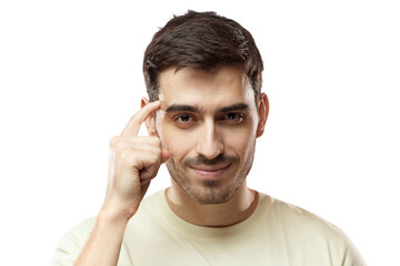 Obraz premium Closeup portrait of young European Caucasian man pictured isolated on pink background pressing finger to temple as if making viewer think more about offer or analyze information better for their good