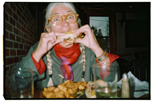Enjoying a Big Bite of a Delicious Sandwich at a Cozy Diner
