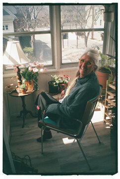Seniors Enjoying a Sunny Afternoon in a Cozy Sunroom