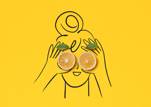 Orange slices as playful illustrated eyes on yellow background