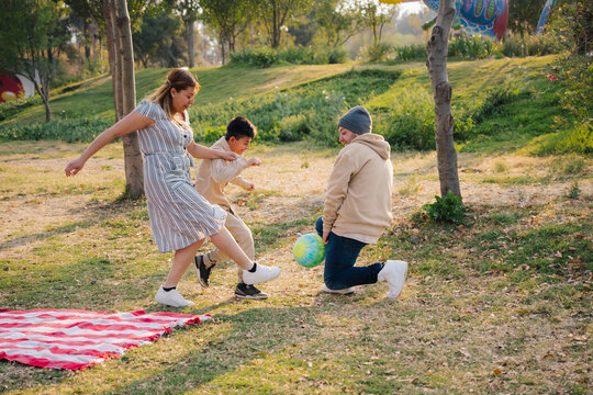 Family Playing Soccer In Park