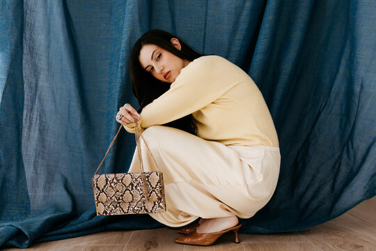 Woman with snakeskin handbag