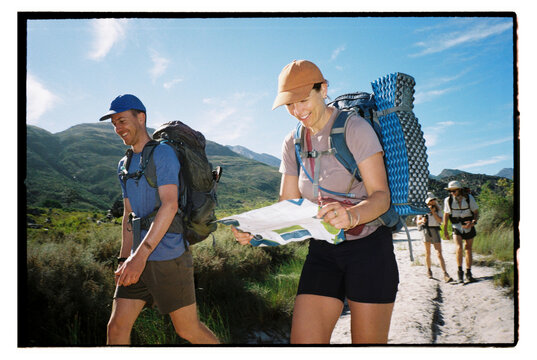 Hikers check route on map
