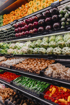 Colorful organic vegetables displayed on grocery shelf