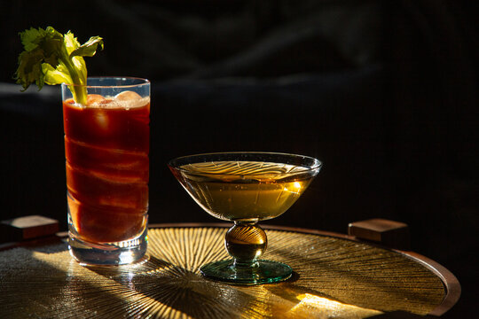 Aperativs on a brass table in low light. 