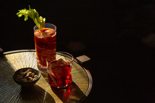 Overhead image of brightly coloured drinks and bar snack.