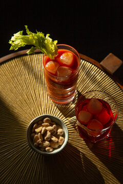 Overhead image of brightly coloured drinks and bar snack.