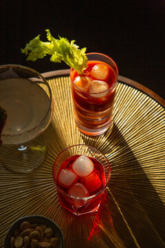 Mixed cocktails on a brass table.