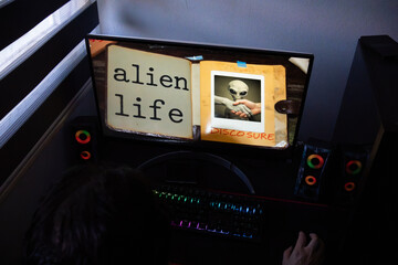 Alien and Human Handshake Disclosure Graphic on Computer Screen, Conceptual First Contact Image with Alien Life Text on Desktop Monitor
