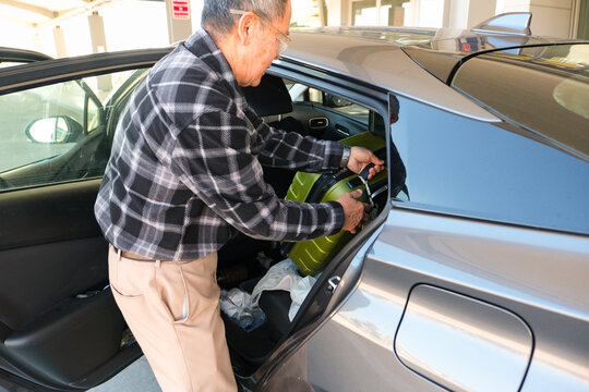 loading suitcase into car 