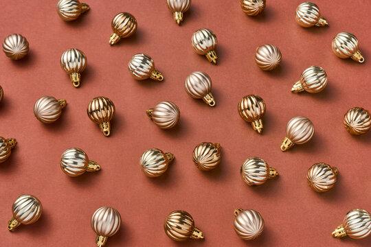 Gold bauble toys pattern on terracotta background