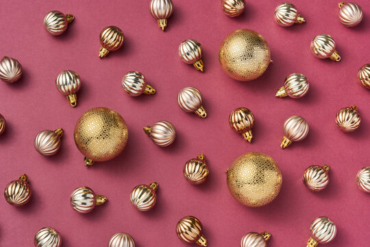 Gold Christmas tree bauble pattern on pink festive background