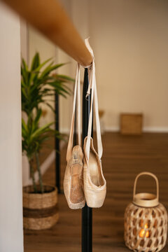 Ballet pointe shoes hanging on studio barre