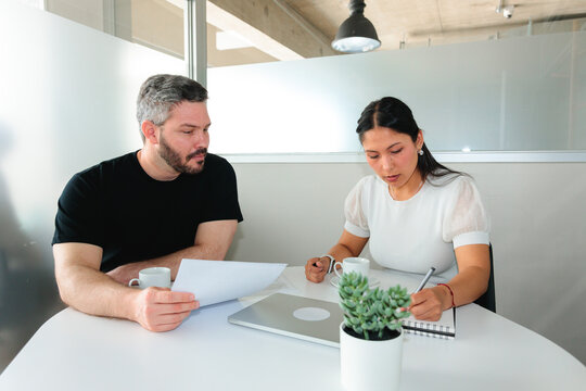 Focused Work Session with Notes and Documents in an Office Cubicle