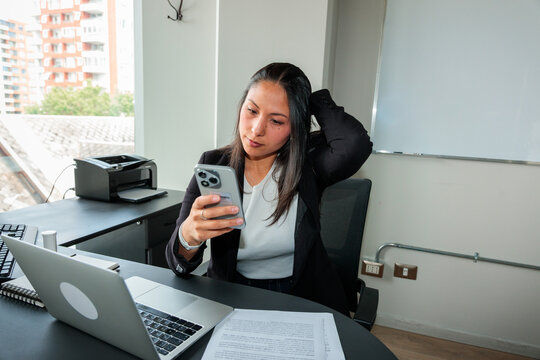 Woman Reading Phone Notification at Work