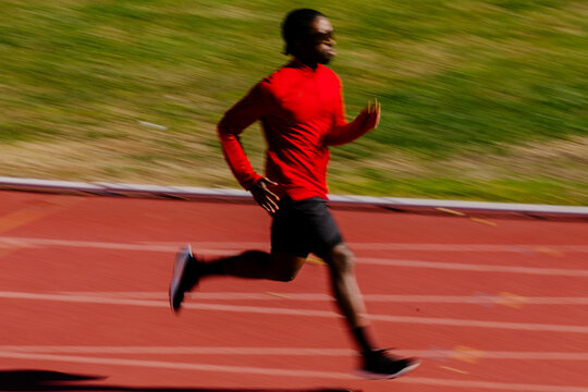 Blurred perspective shows a sprinter in motion