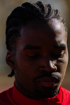 Tight frame of a dedicated runner, mentally preparing for his training