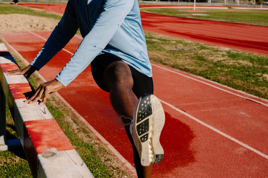 Anonymous athlete moving through warm-up actions to activate muscles