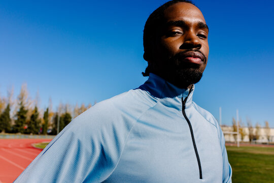 Professional athlete standing confidently and exuding focus and energy