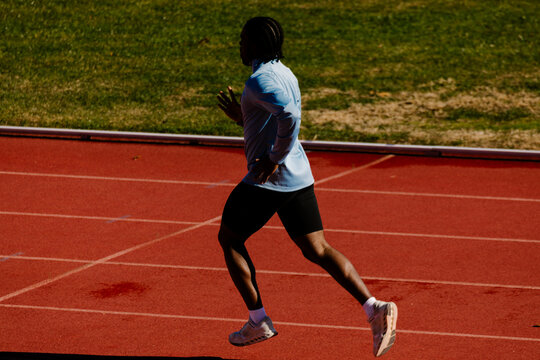 Back view of a runner pushing through rapid sprint repetitions