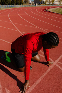 Runner refining his launch posture while preparing for a sprint