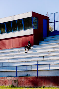 Distant view of a runner making sure his footwear is properly set