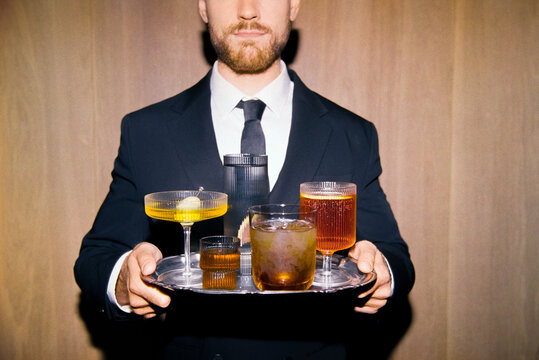 Elegant bartender with tray