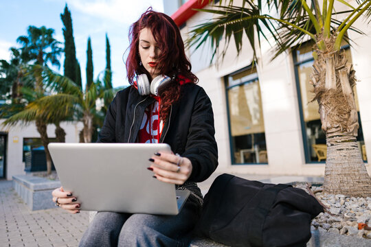 Young woman studying with laptop on campus