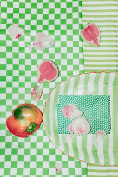 Setting food on checked tablecloth with vegetables