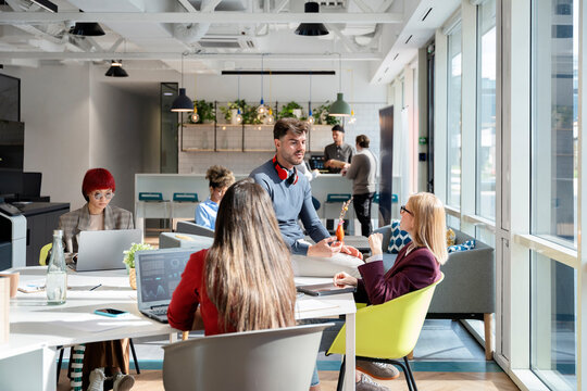 Diverse startup team collaborating in modern coworking office