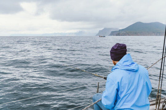Fishing from a boat near the rocky coastline