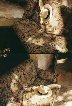 Hat Resting on a Patterned Couch in a Cozy Setting