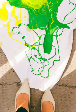 Bright Paint Splashes on White Canvas With Shoes Nearby
