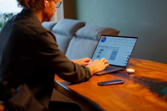 Working on laptop at a desk during evening hours
