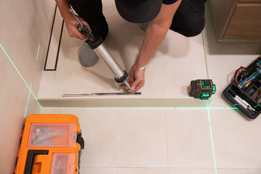 Worker Uses Silicone For Shower Installation Works