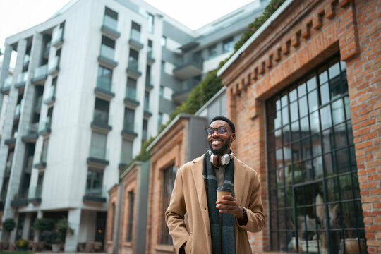 Man standing near brick building in city

