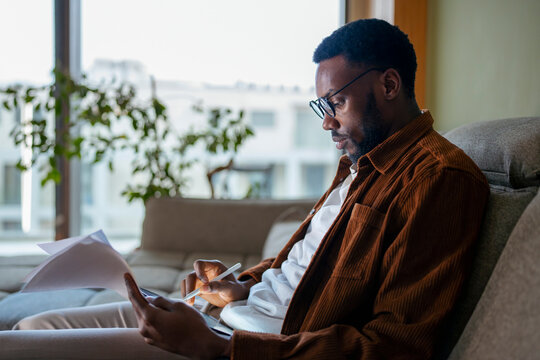 Man reading at home in daylight
