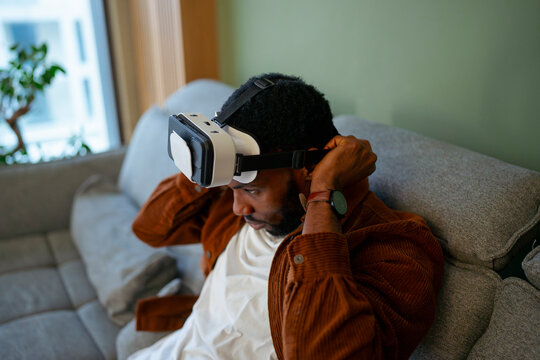Man puts on virtual reality headset
