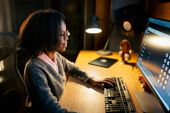 Woman working at desk late at night
