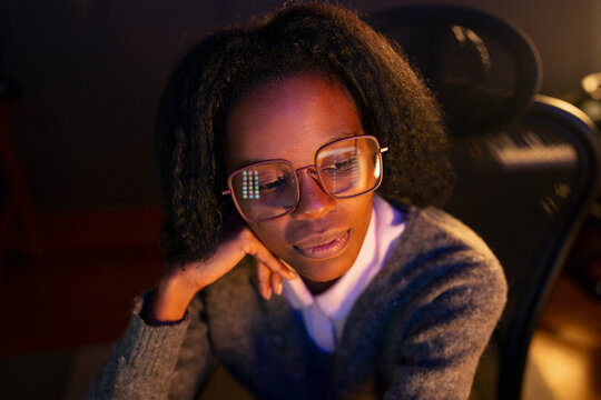 Woman working at night in an office
