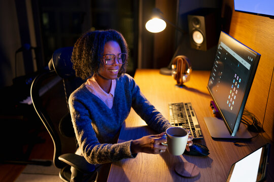 Working late at night with a warm drink
