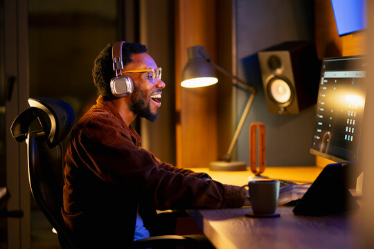 Man listens to music at desk
