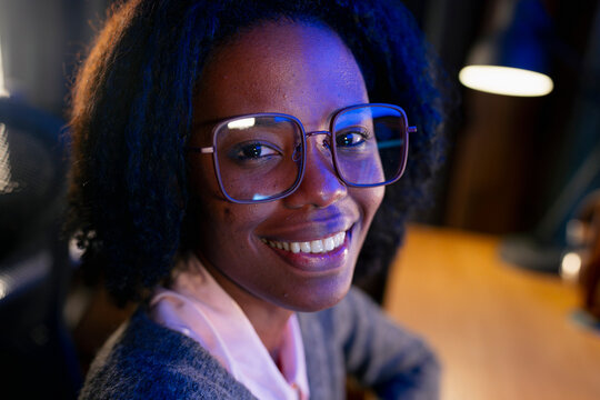 Young woman smiles at work
