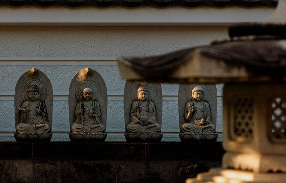 Zen of the Sunset: Four Stone Buddhas Bathed in Divine Light.