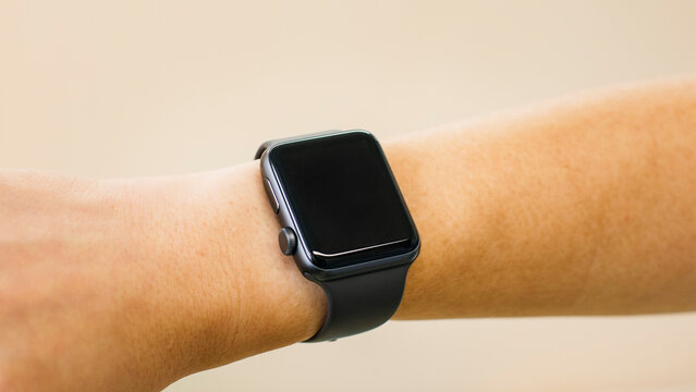Man using a smartwatch showing a blank black screen