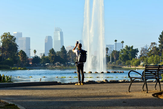 Tourist takes photos of the Echo park lake