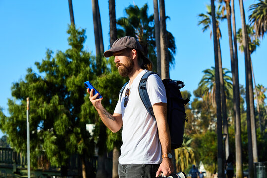 Man uses his phone in Echo Park, CA.