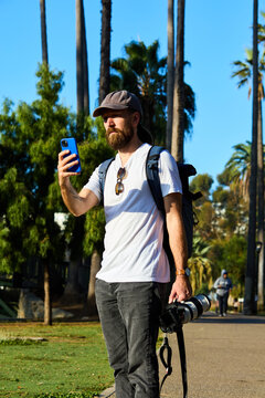 Tourist takes pictures in Echo Park, CA.