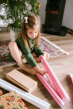 The child is wrapping presents.